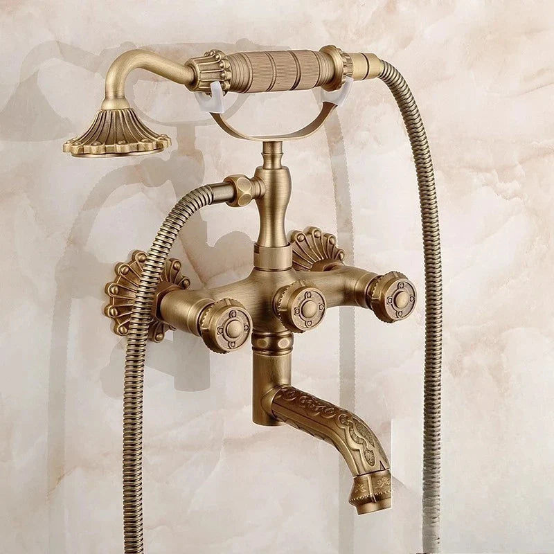 Antique brass bathtub shower set with vintage brass finish ornate detailing and three separate control knobs