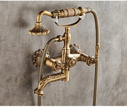 Antique brass bathtub shower set with vintage wall-mounted faucet featuring ornate detailing and flexible hoses