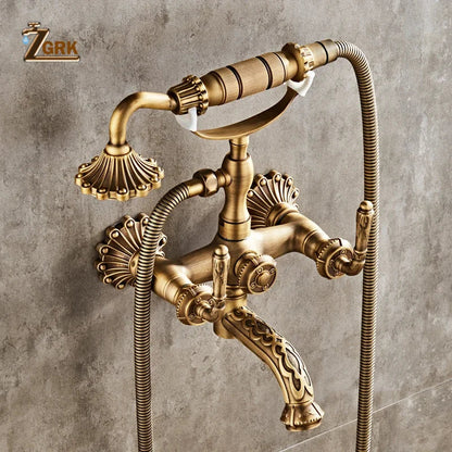 Antique brass bathtub shower set with vintage-style faucet, ornate shell-shaped handles, and decorative scrollwork