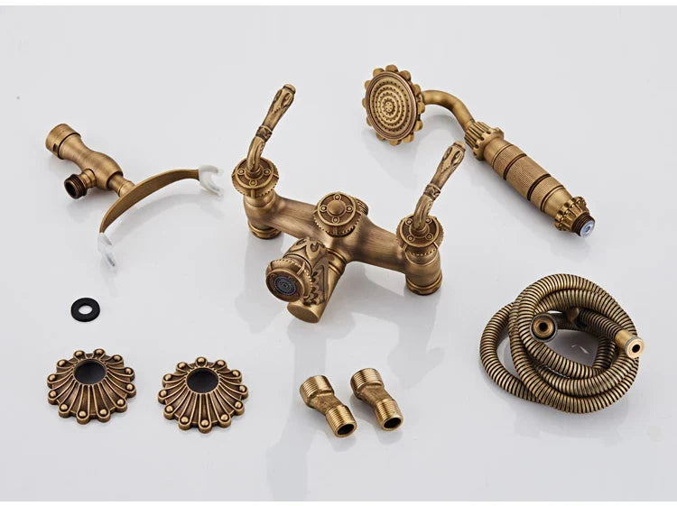 Antique brass bathtub shower set with vintage style ornate detailing and matching showerhead in brass finish
