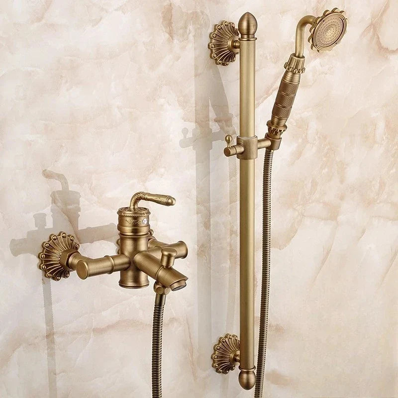 Antique brass bathtub shower set with ornate shell-shaped wall mounts and handheld showerhead in brass finish