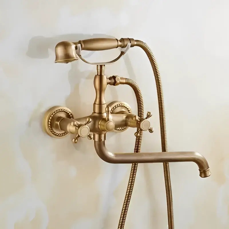 Antique brass bathtub shower set with ceramic handles and a wall-mounted brass shower set with curved spout and handheld spray head