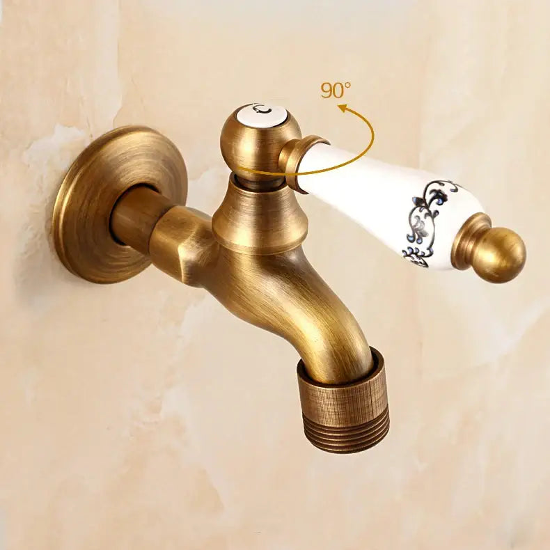 Antique brass bibcock faucet with brass antique finish and white ceramic handle with black floral detailing for garden use