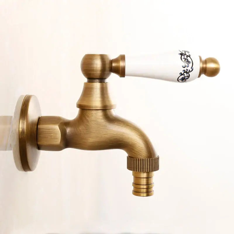Antique brass bibcock faucet with white ceramic handle featuring black floral patterns for garden tap decorbites brass antique