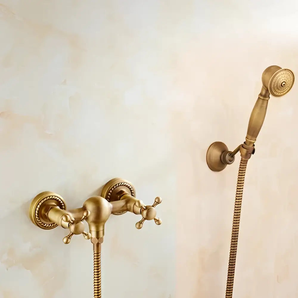 Antique brass bidet mixer faucet set with ornate cross handles and matching handheld showerhead in brass finish