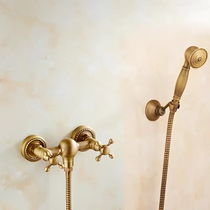 Antique brass bidet mixer faucet with ornate cross handles and matching handheld showerhead for bathroom use