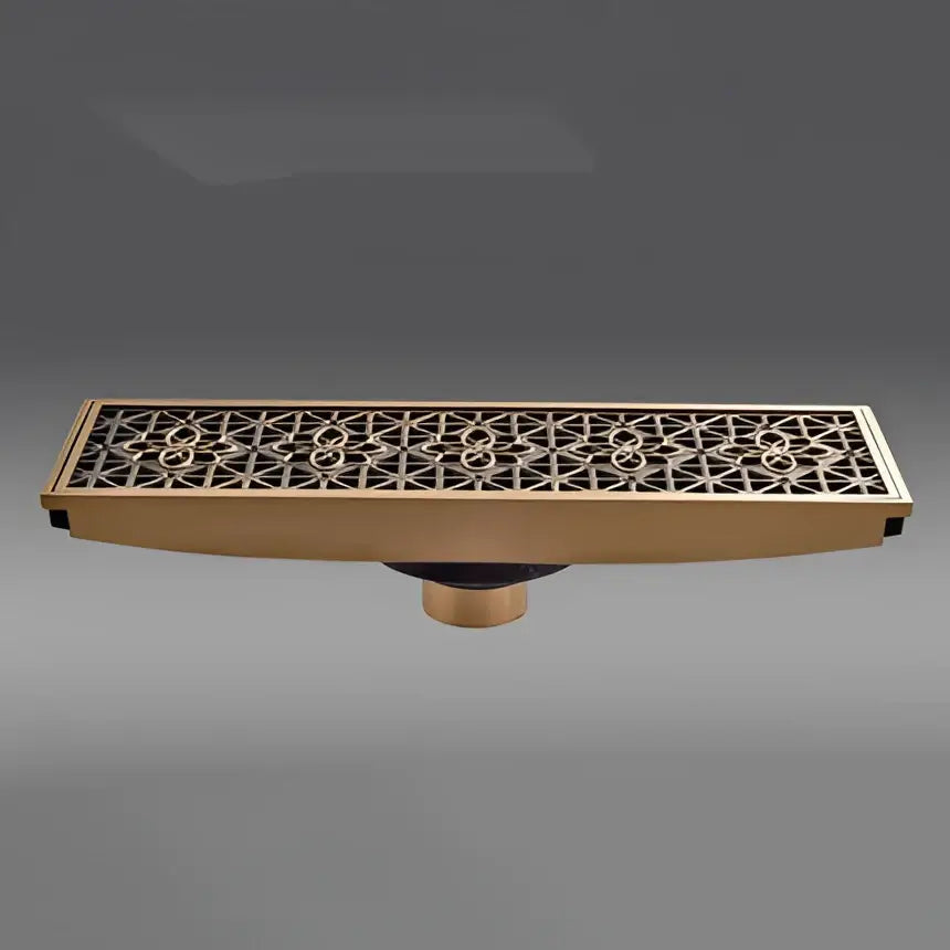 Antique brass carved floor drain cover with intricate geometric floral pattern brass-colored rectangular drain cover