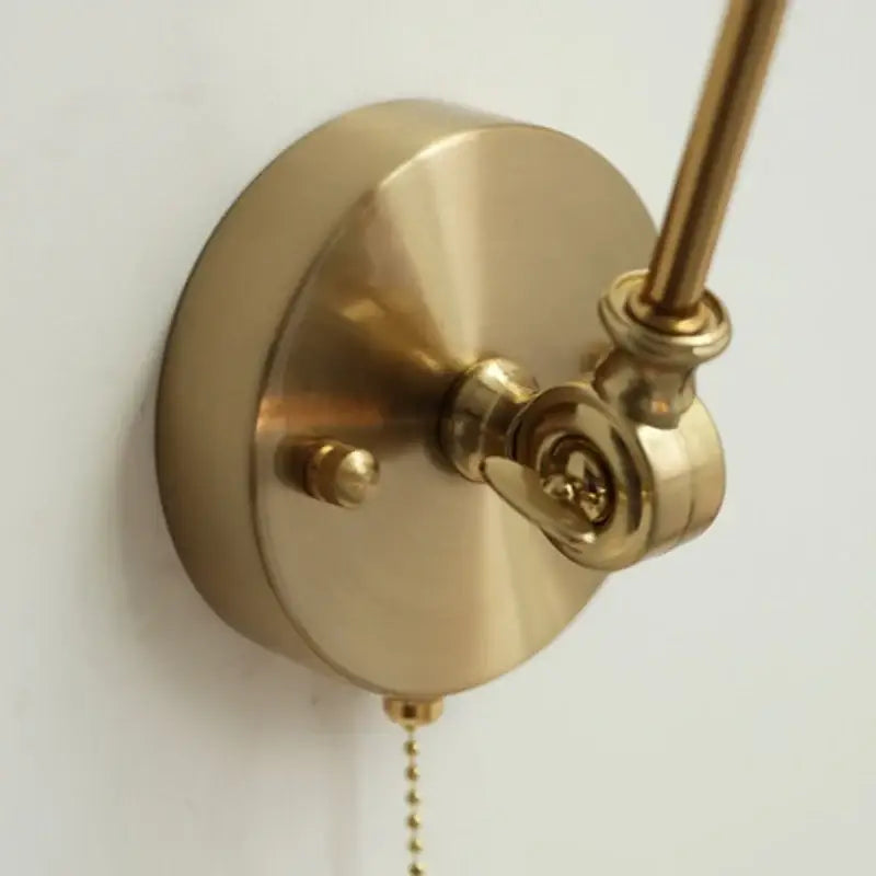 Brass-finished antique ceramic copper led wall light with sleek circular base and adjustable arm for bedroom decorbites sconce