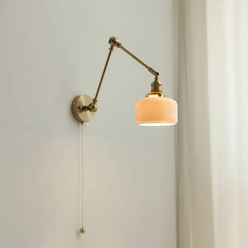 Brass-finished adjustable wall light with ribbed warm glass shade and pull-chain switch decorbites ceramic copper led bedroom sconce