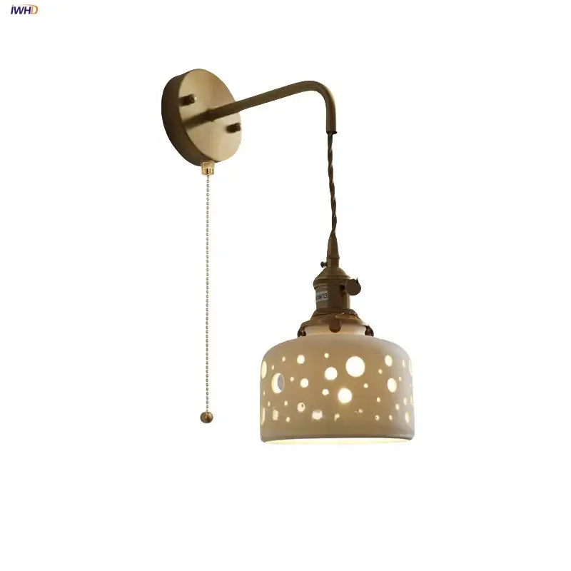 Antique brass ceramic led wall light with cream ceramic shade and decorative cutouts for bedroom decorbites ceramic led