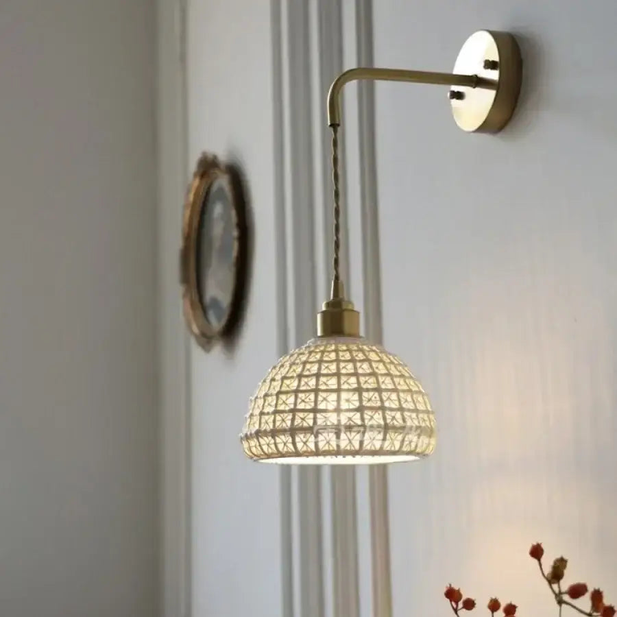 A warm-toned antique brass ceramic led wall light with a woven rattan shade for bedroom decorbites ceramic led wall