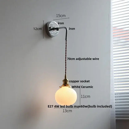 Antique brass ceramic led wall sconce featuring a white ceramic globe pendant with a brass copper socket and adjustable iron arm