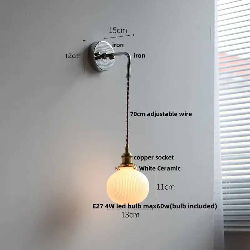 Antique brass ceramic led wall sconce featuring a white ceramic globe pendant with a brass copper socket and adjustable iron arm