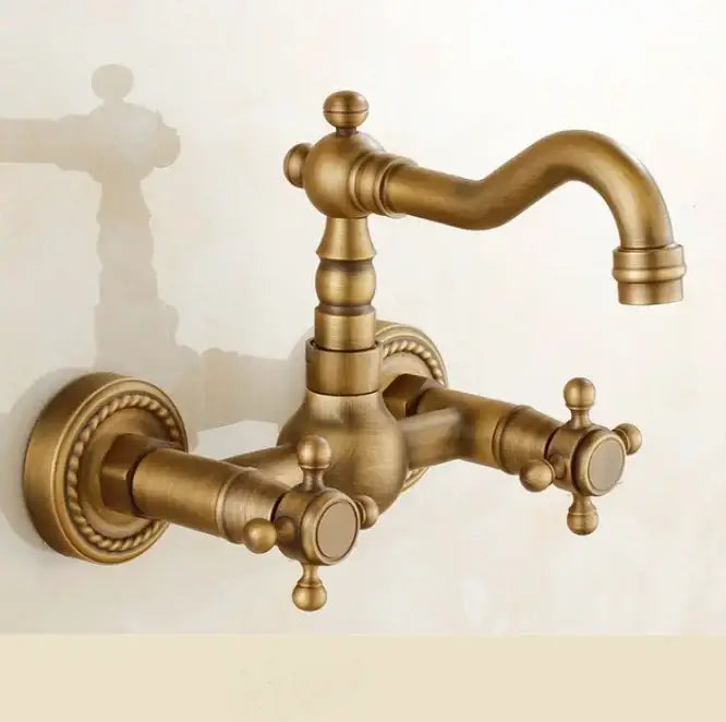 Antique brass ceramic wall mount faucet with ornate detailing and cross handles for vintage kitchen decorbites brass ceramic