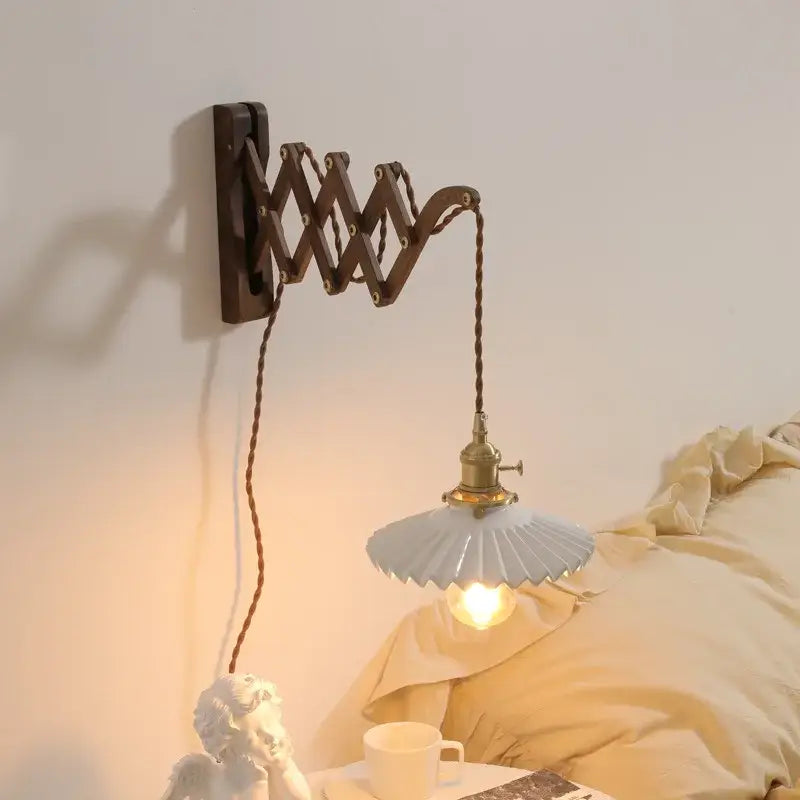 Antique brass ceramic walnut wall sconce with dark wooden arm and pale blue fluted scalloped ceramic walnut shade bedroom decorbites