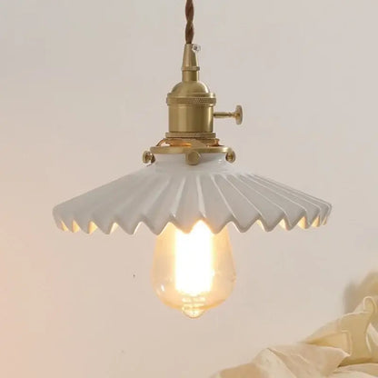 White ceramic walnut wall sconce with fluted scalloped shade and antique brass decorbites ceramic walnut hardware