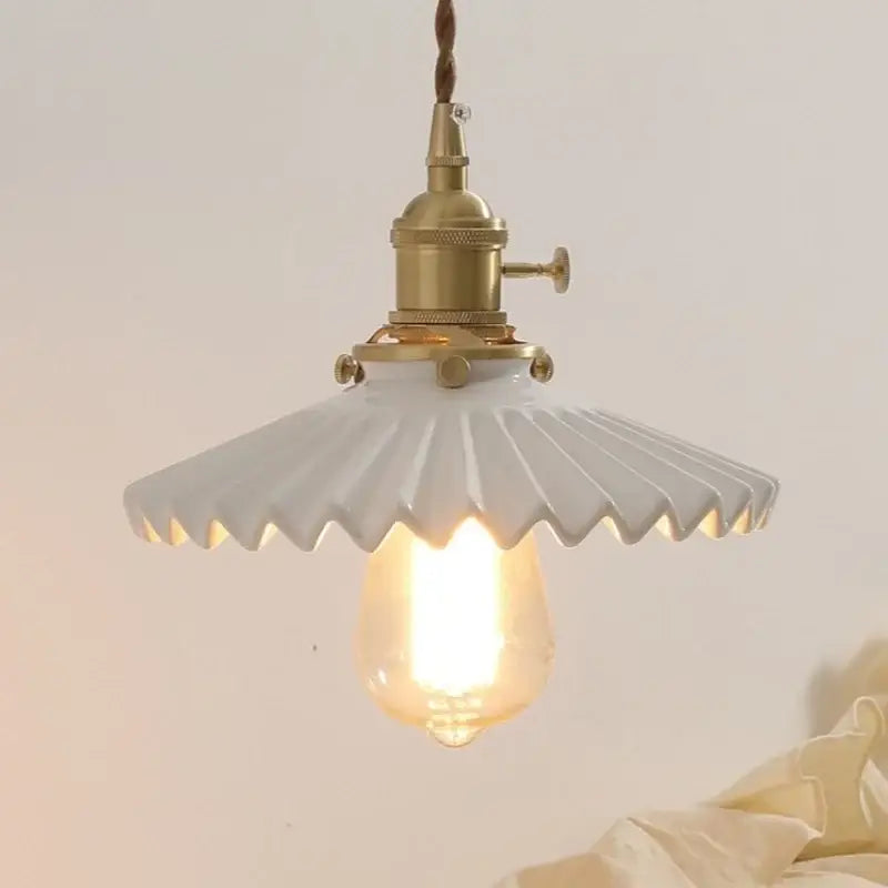 White ceramic walnut wall sconce with fluted scalloped shade and antique brass decorbites ceramic walnut hardware