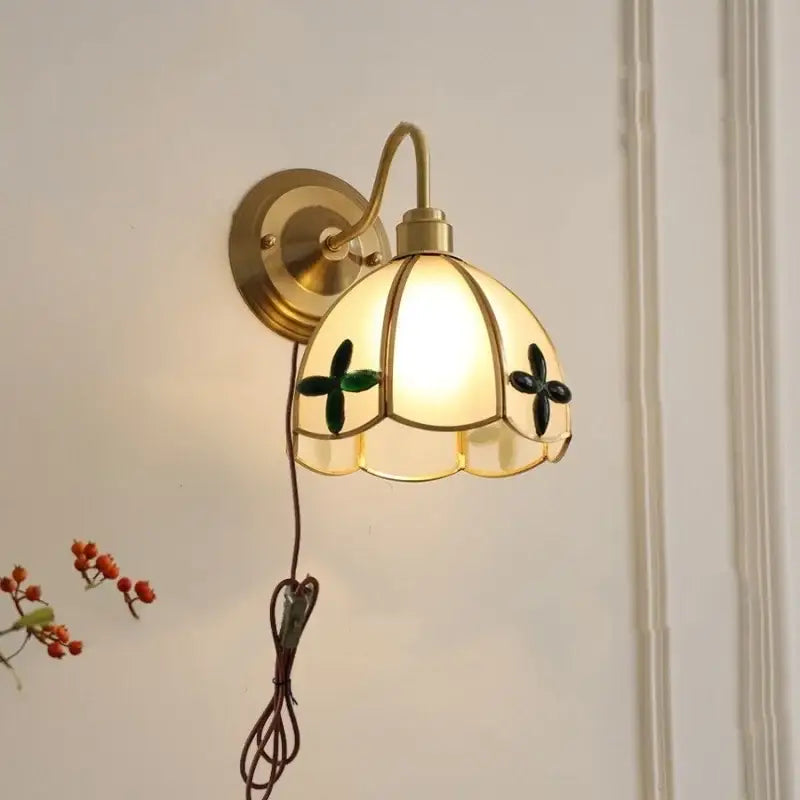 Antique brass clover glass brass wall sconce with cream petal-shaped stained glass shade and green black floral accents