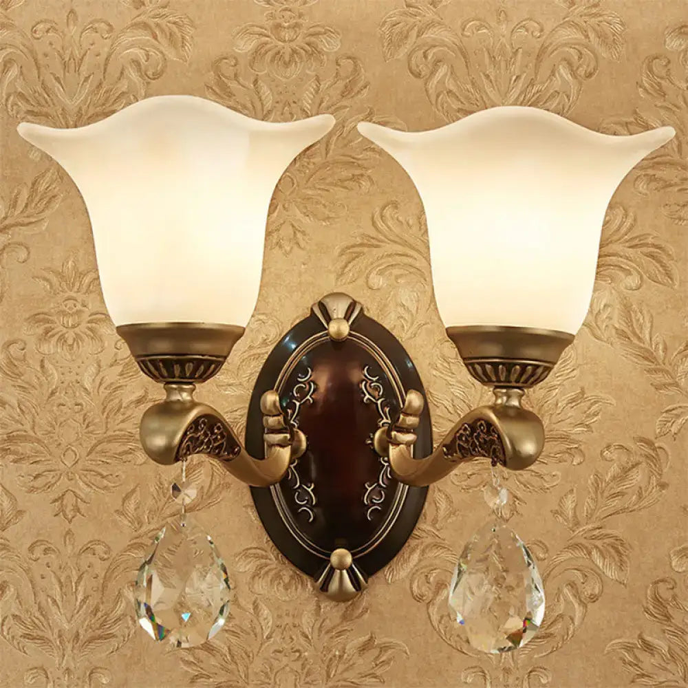 Antique brass two-light wall lamp with frosted glass shades and crystal drops compatible with e12 e14 base bulbs