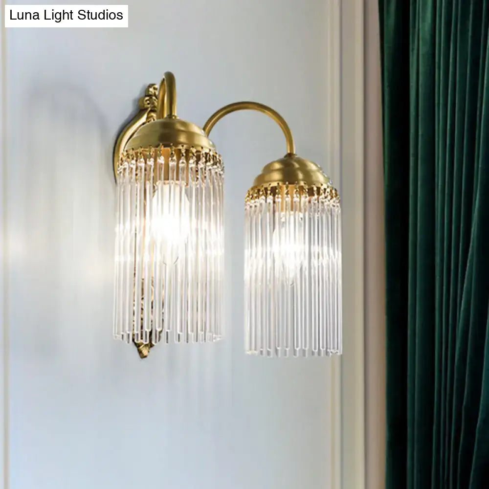 Antique brass crystal rod wall sconce with cascading clear crystal prisms for ornate corridor lighting