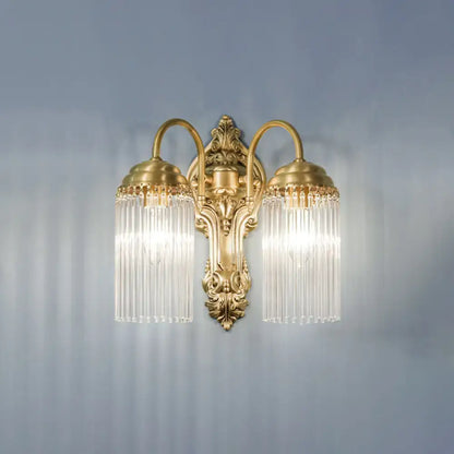 Antique brass crystal rod wall sconce with gold-toned two-arm design and cascading clear glass prisms for corridor lighting