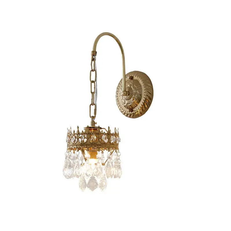 Antique brass crystal wall lamp featuring a crown-like frame with clear crystal droplets for luxury bedroom decorbites wall lamp