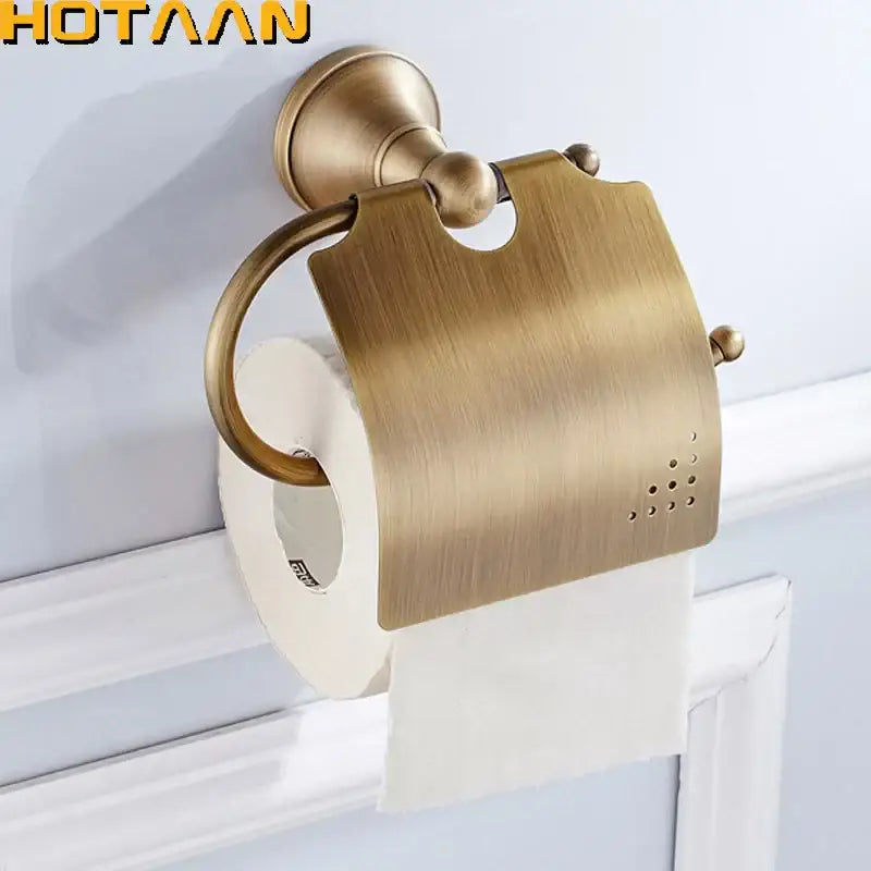Antique brass curved toilet paper holder with brass finish and decorative spherical accents for bathroom use