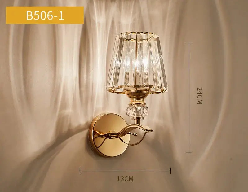 Gold-toned antique brass and dark bronze decorbites crystal led wall lamp with faceted crystal shade and decorative accents