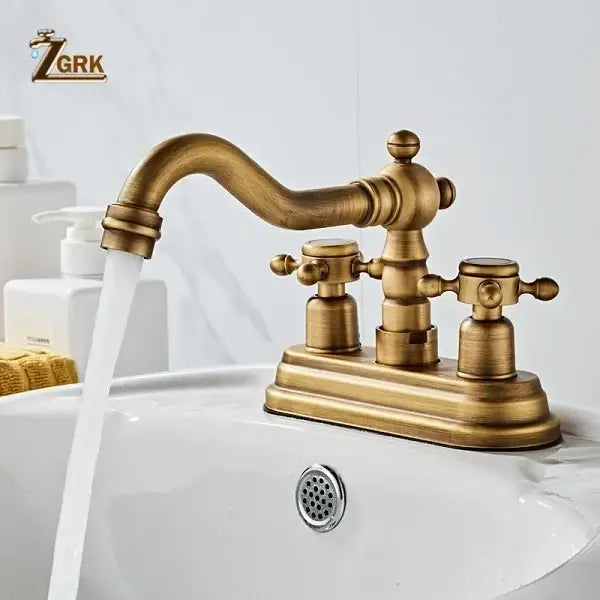 Antique brass deck mounted double handle basin sink faucet with housing material brass and ornate curved spout detailing