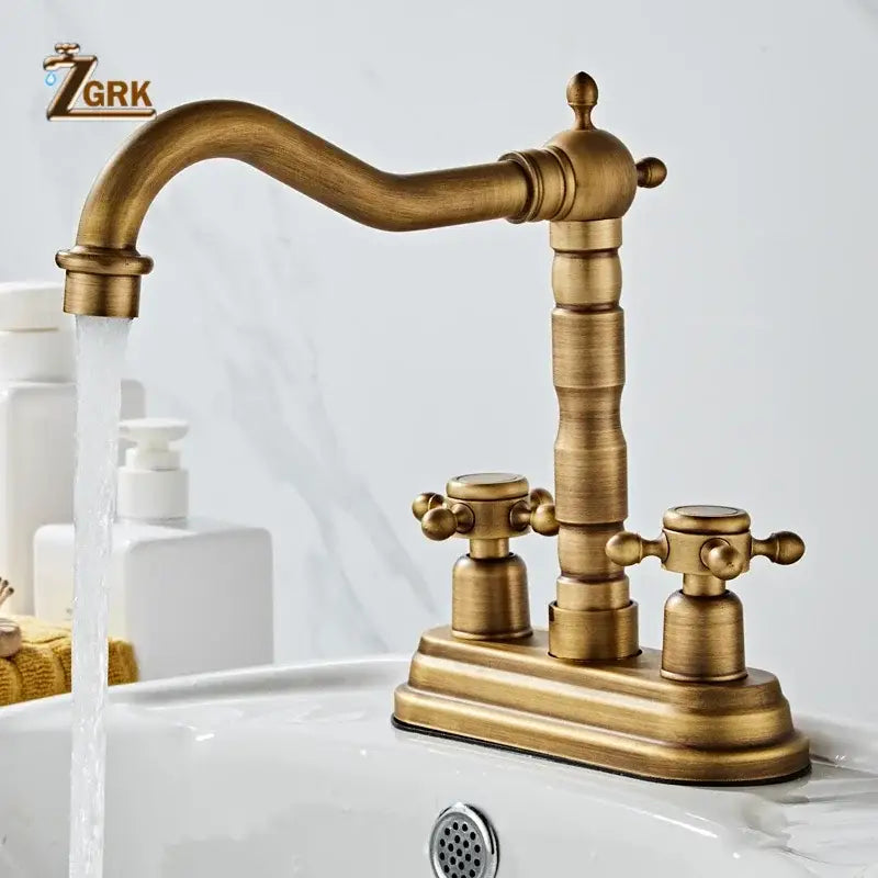 Antique brass deck mounted double handle basin sink faucet with ornate cross handles and curved spout housing material brass