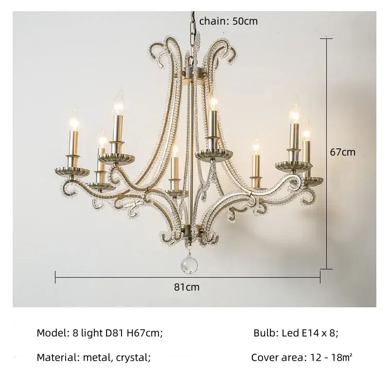An ornate silver decorbites crystal led chandelier with eight lit candle-style bulbs for living room lighting
