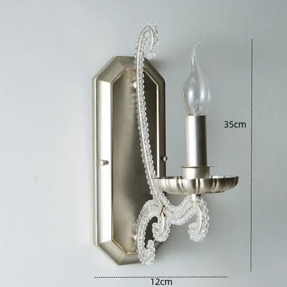 Silver-toned decorbites crystal led wall sconce with clear crystal accents and candle-style bulb for elegant lighting