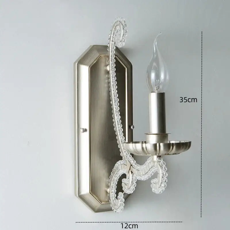 Silver-toned decorbites crystal led wall sconce with clear crystal accents and candle-style bulb for elegant lighting