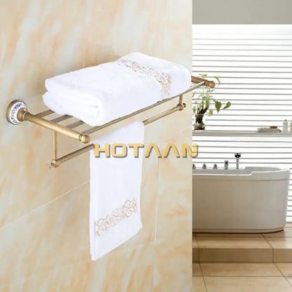 Antique brass double tier towel rack with gold-toned metal and ceramic towel holder featuring embroidered towels