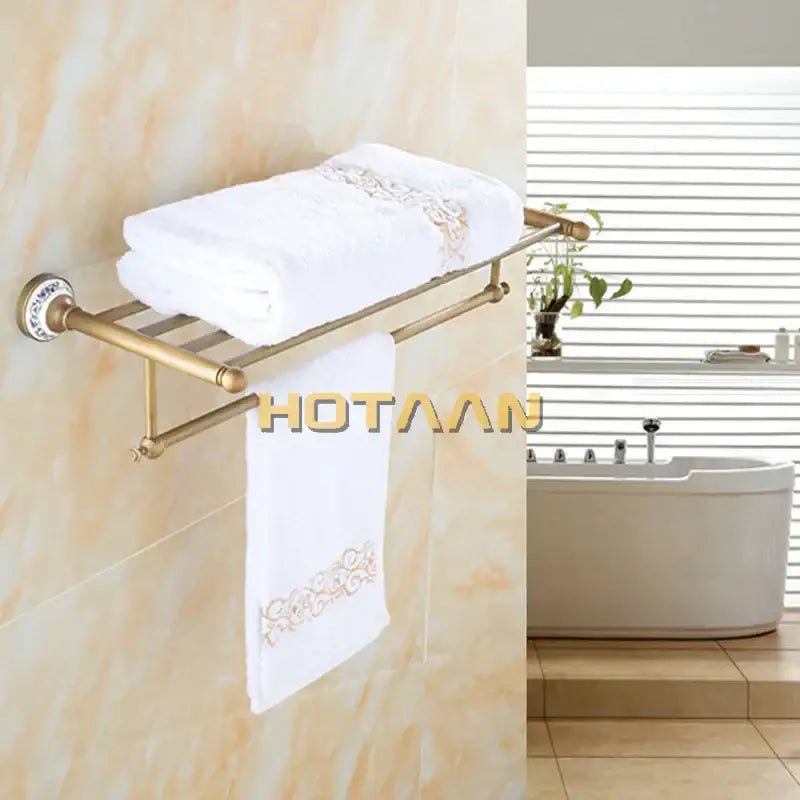 Antique brass double tier towel rack with gold-toned metal and ceramic towel holder featuring embroidered towels