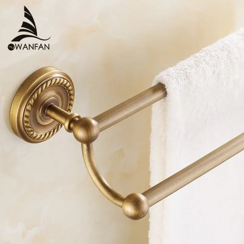 Antique brass double towel bar with ornate circular base and spherical finials for bathroom use