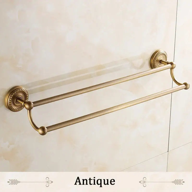Antique brass double towel bar bathroom rack with ornate circular wall mounts and rounded end caps