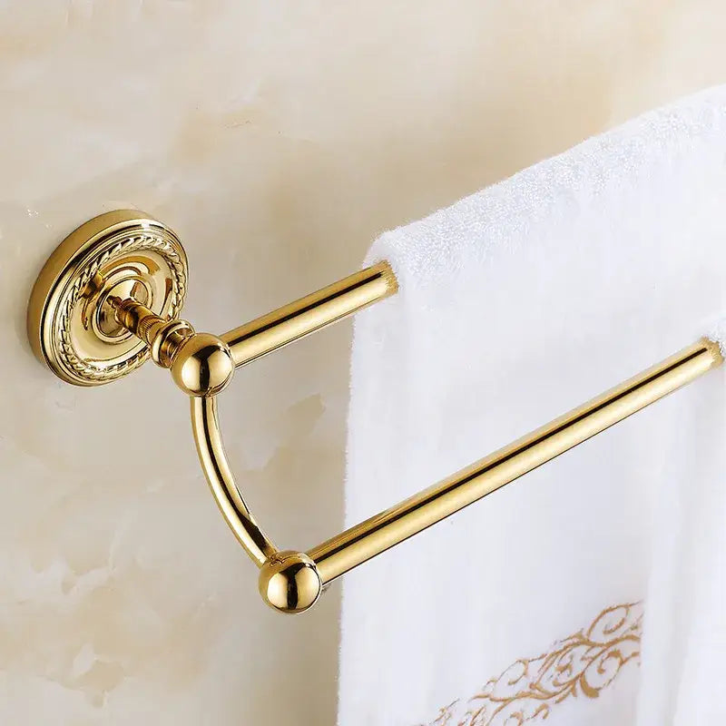 Antique brass double towel bar with gold finish, ornate circular base, and polished metal bars for bathroom use