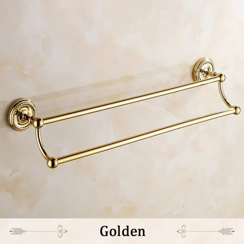 Antique brass double towel bar with ornate circular wall mounts and polished brass finish for bathroom use