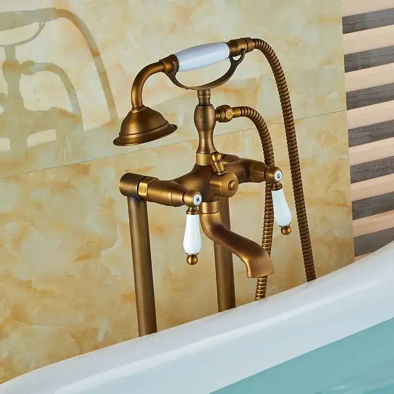 Antique brass freestanding tub faucet with decorbites dual ceramic handle and flexible shower hose for bathroom use