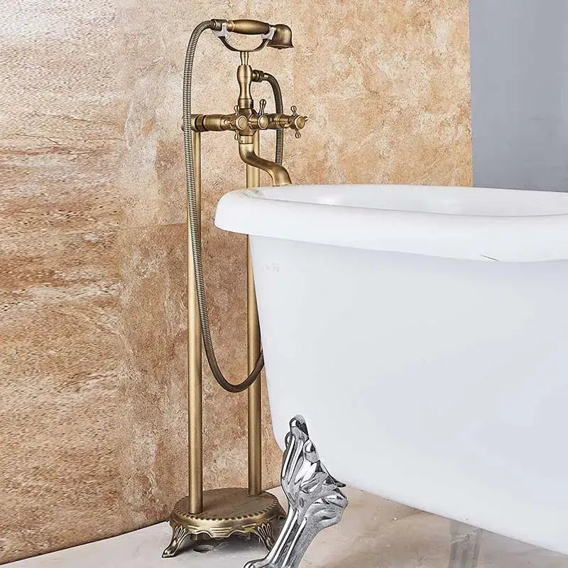 Antique brass freestanding tub faucet with ornate spout and decorbites dual ceramic handle on pedestal base