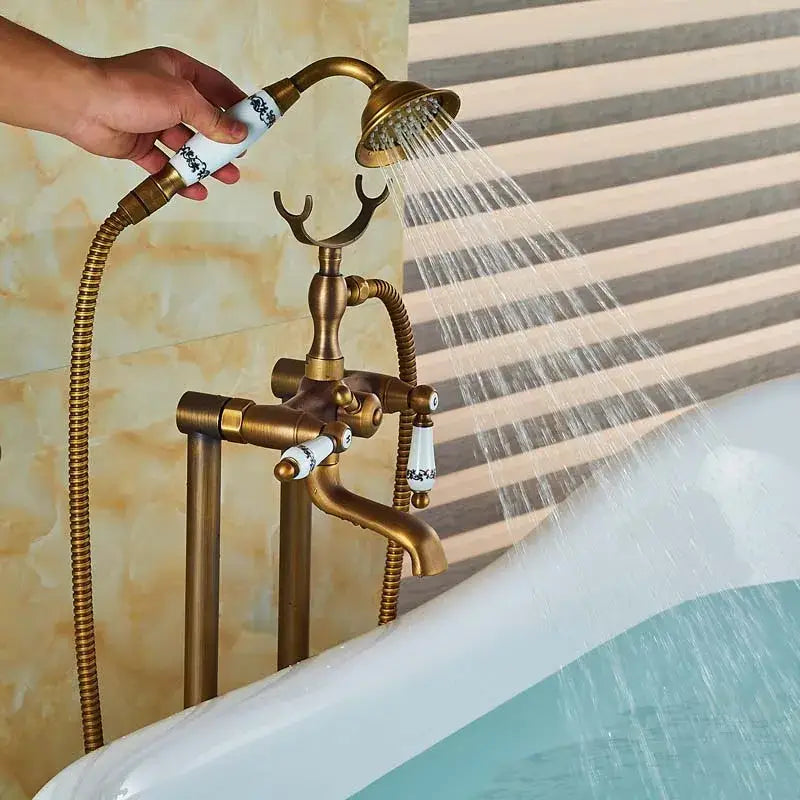 Antique brass freestanding tub faucet with decorbites dual ceramic handle and black floral pattern on white ceramic