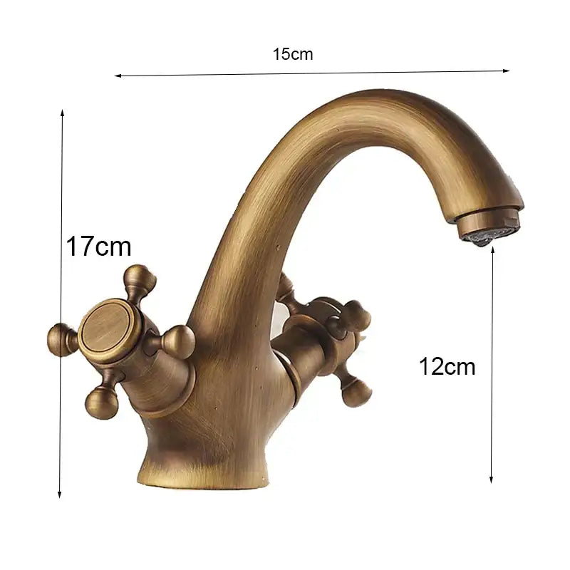 Antique brass dual handle basin faucet with curved spout and ornate cross handles for bathroom vanity by decorbites