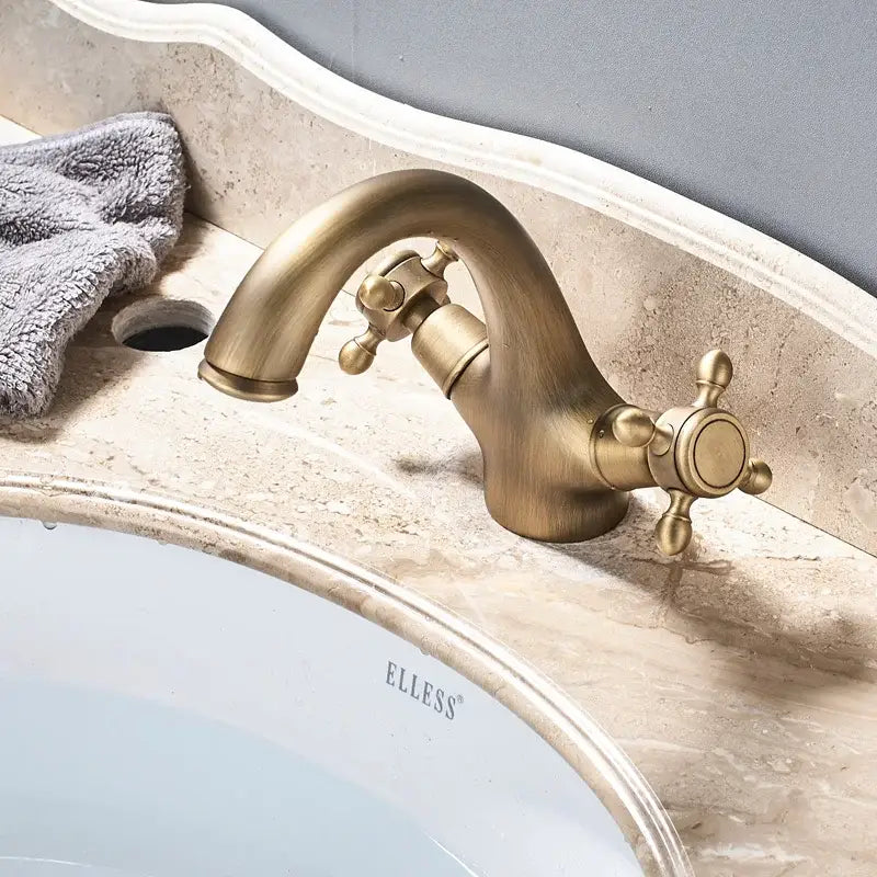 Antique brass dual handle basin faucet with cross handles and curved spout for bathroom vanity decorbites dual handle