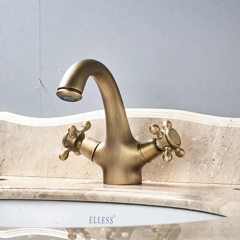 Antique brass dual handle basin faucet with curved spout and cross-shaped knobs for bathroom vanity sink by decorbites
