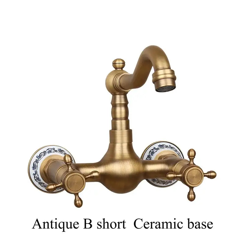 Antique brass dual handle kitchen faucet with hot water control and ornate ceramic base with blue floral patterns