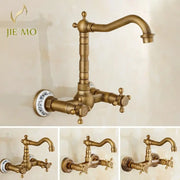 Antique brass dual handle kitchen faucet with hot water function and decorative blue and white porcelain plate base