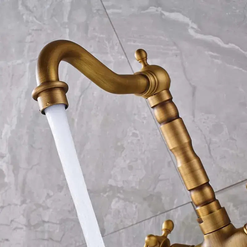 Antique brass dual handle swivel sink faucet with curved spout and ornate segmented handles for kitchen decorbites dual handle