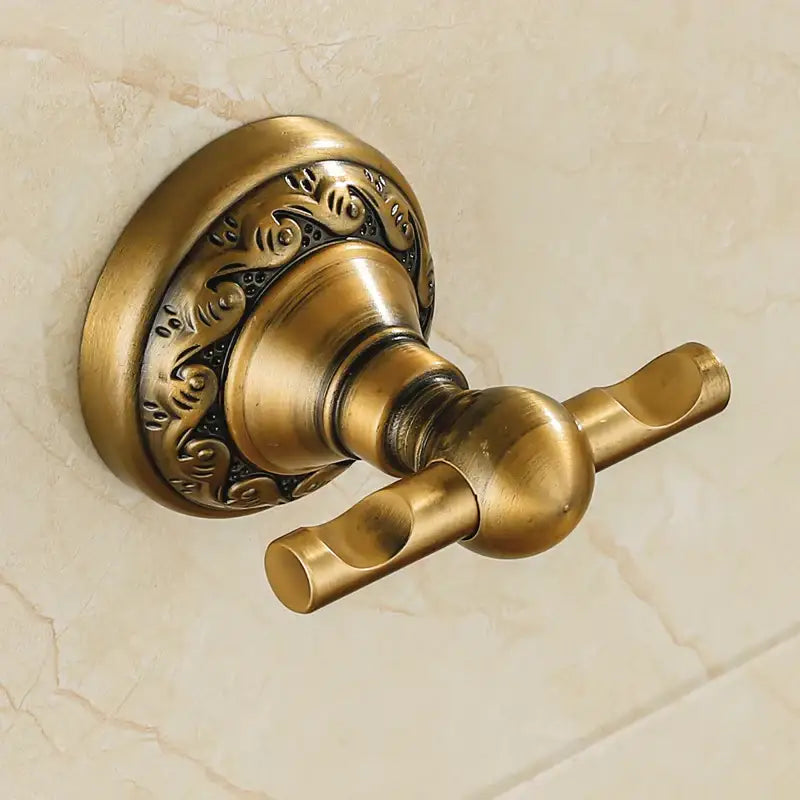 Antique brass double towel rack with ornate floral engraving on circular base in decorbites bathroom hardware set