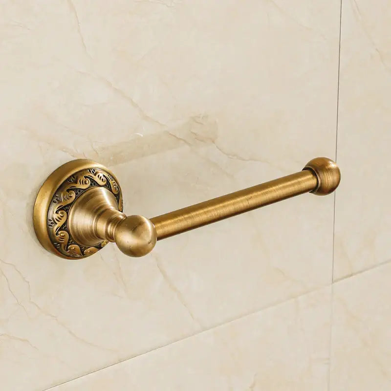 Antique brass floral engraved double towel rack with ornate circular base and polished spherical ends in bathroom hardware set